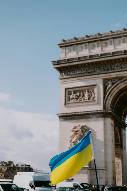 an ukraine flag is flying in front of a large arch