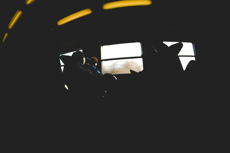 silhouette of people looking out of an airplane window