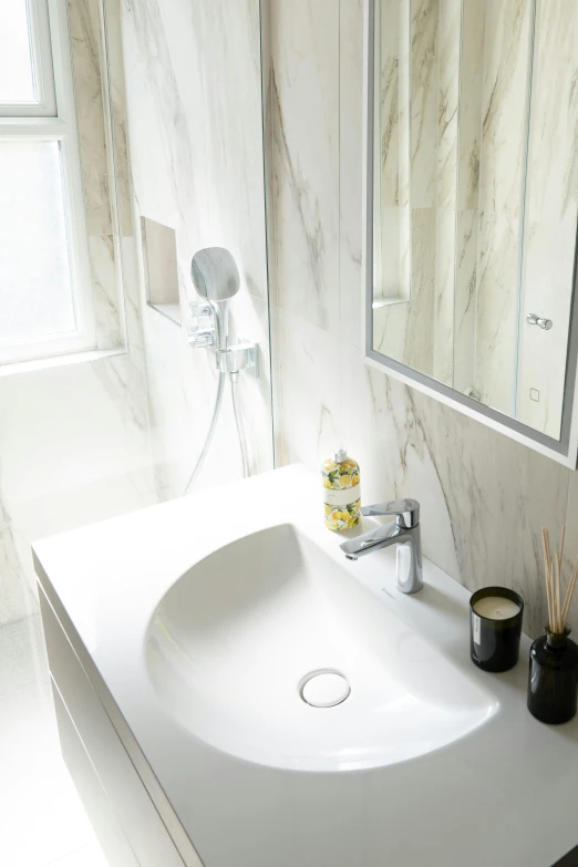 a bathroom sink with a large mirror behind it