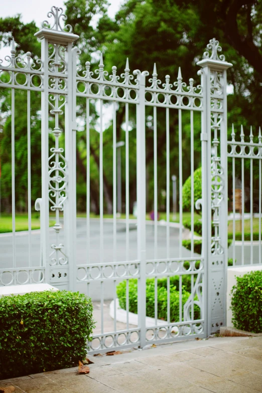 a white gate on the side of a street