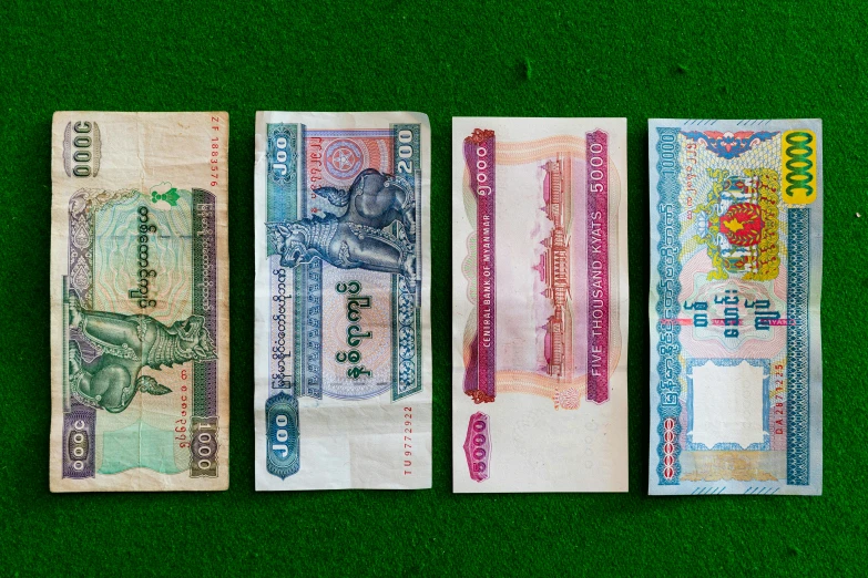 a row of different types of paper money