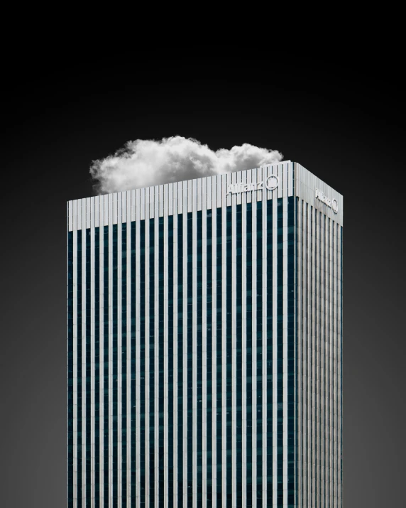 a large blue building with several windows next to a cloud in the air