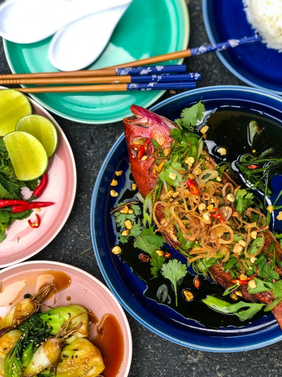 a table topped with blue dishes filled with food