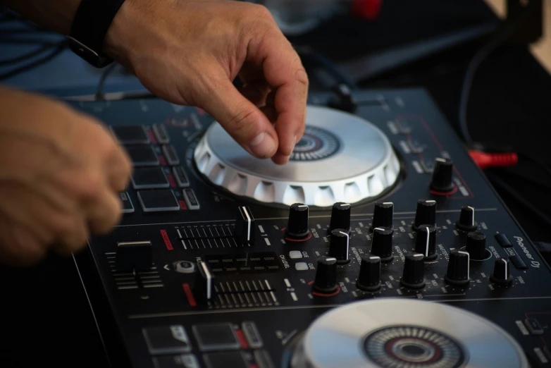 a dj mixes some track tracks with his hands