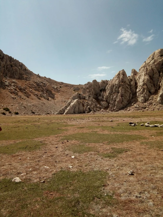 two large rocks in the middle of a grassy field