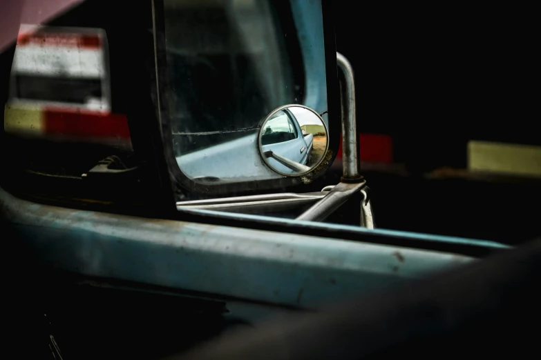 a car mirror with the reflection of a person in it