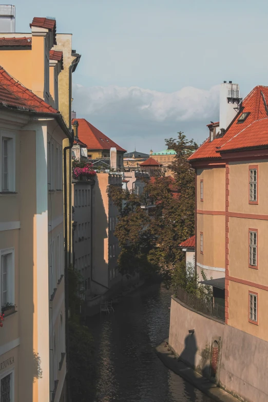 a waterway in front of two apartment buildings next to a river