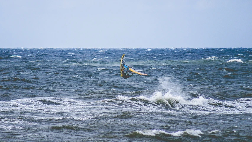 a person riding a board on top of the ocean