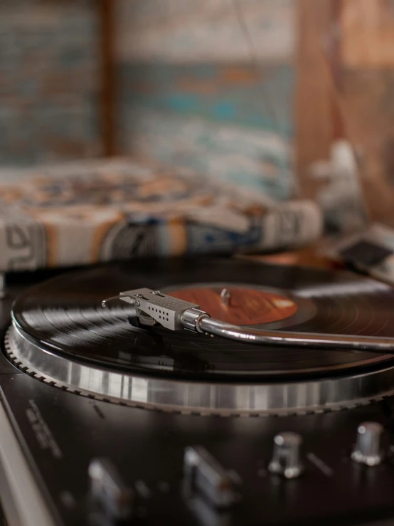 a record player's turntable with an old time - looking record on it