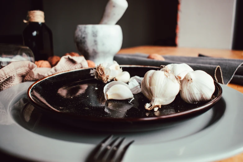 the plate is on top of the table with garlic