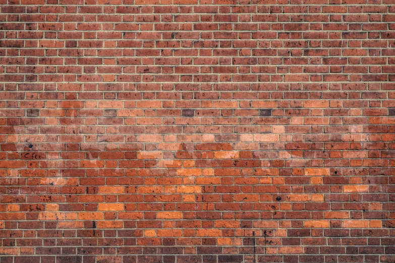 a red brick wall with lots of orange paint