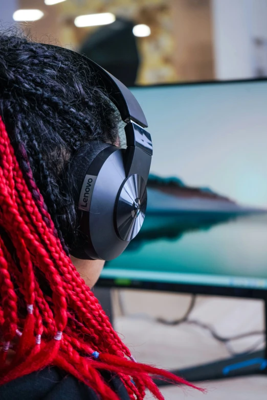 the person wearing headphones has a red scarf over their neck