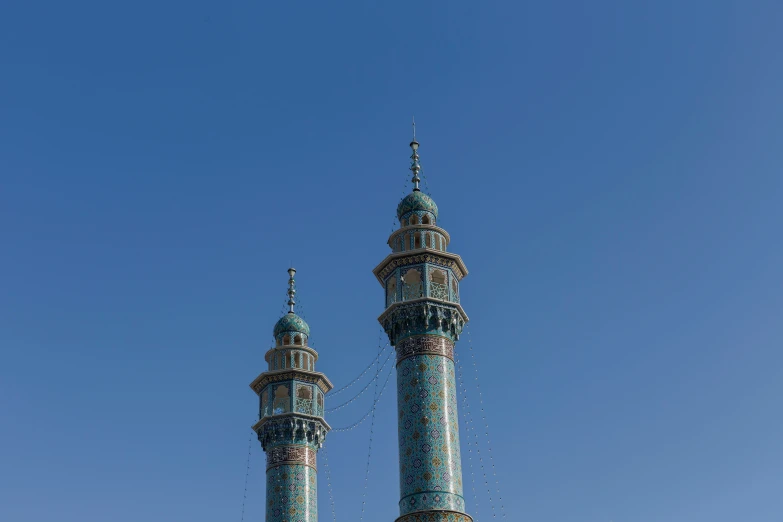 two tall towers in the air with a blue sky