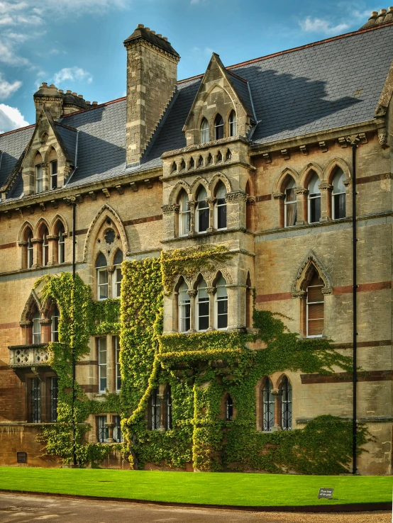 a large old castle building has ivy growing all over it