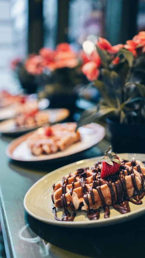 a stack of waffles and strawberry slices on a plate