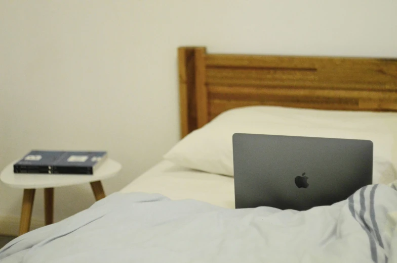 an apple computer on a bed in a room