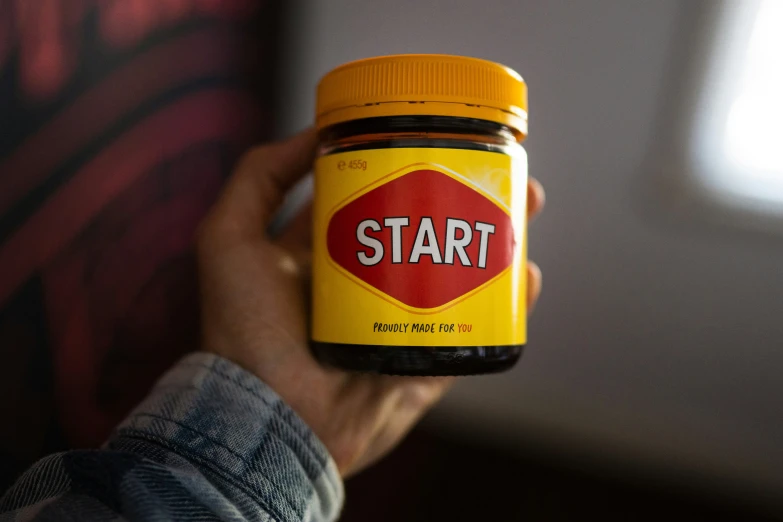 someone holding up a jar of start