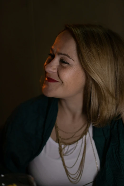 a beautiful blonde woman smiling while sitting down