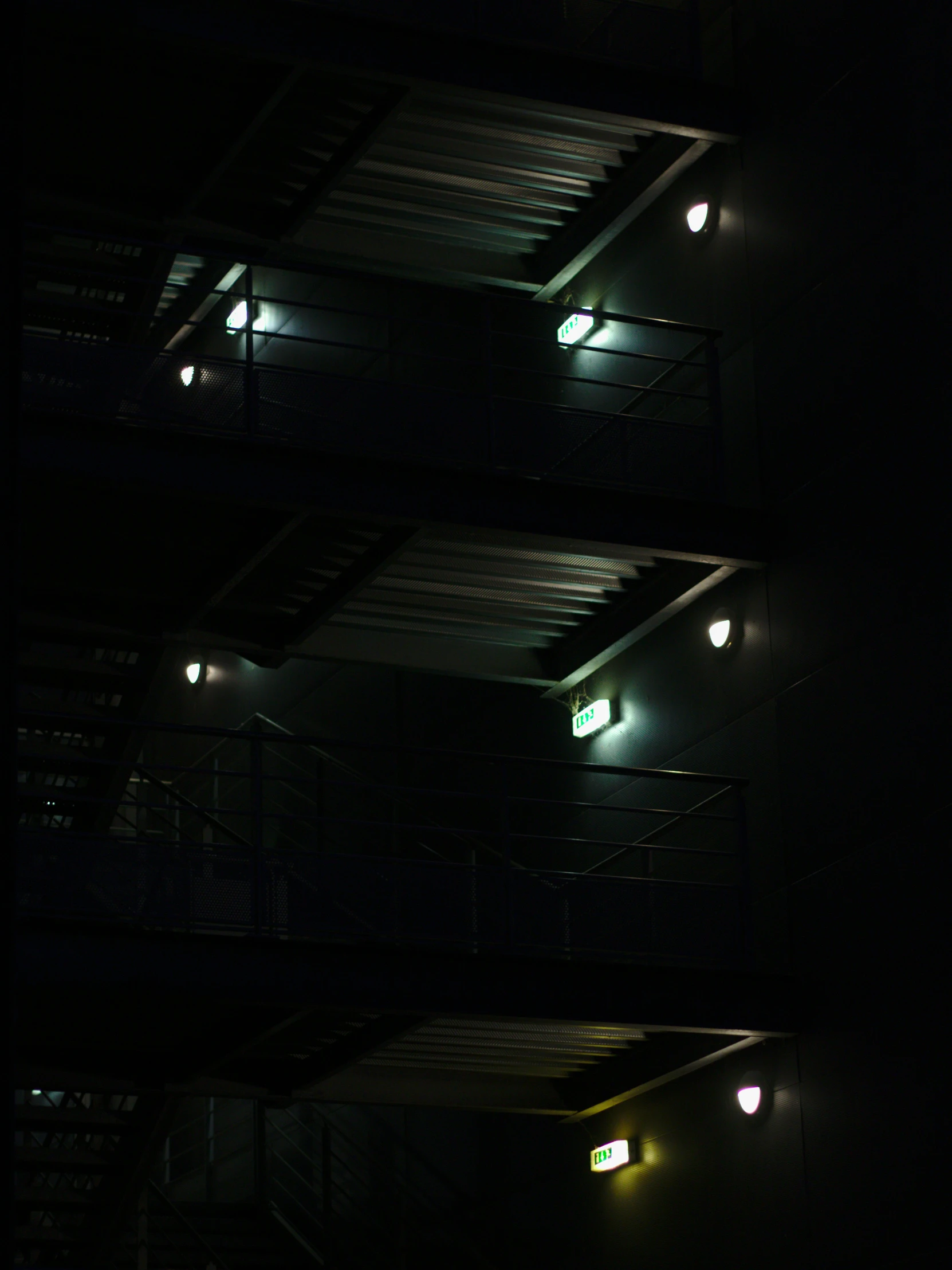 three night lights with four balconies are shown in the dark