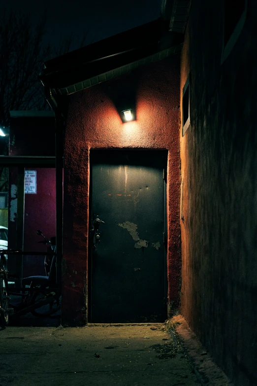 a garage door in a dark and dusty alley