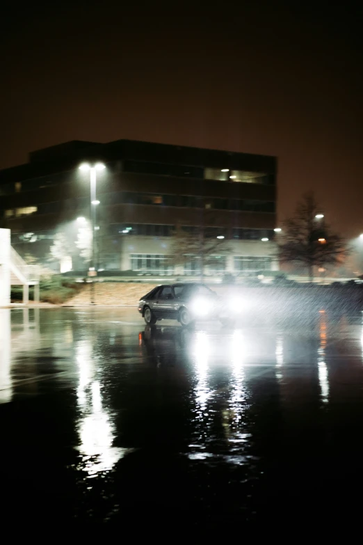 car driving on a city street at night in heavy rain