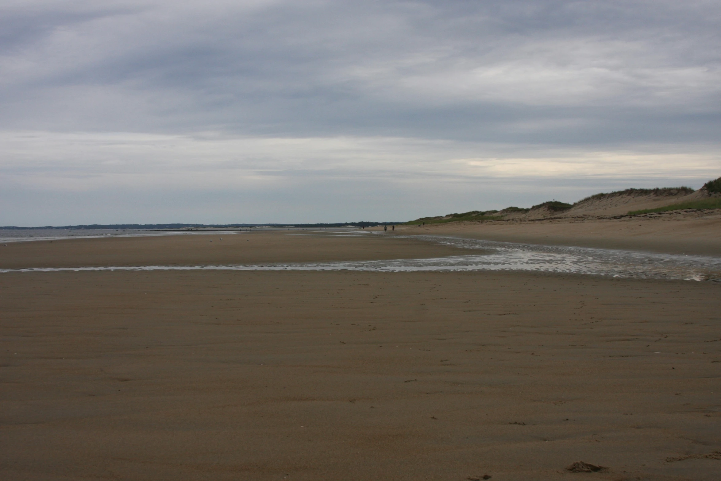 a small beach in front of a shoreline