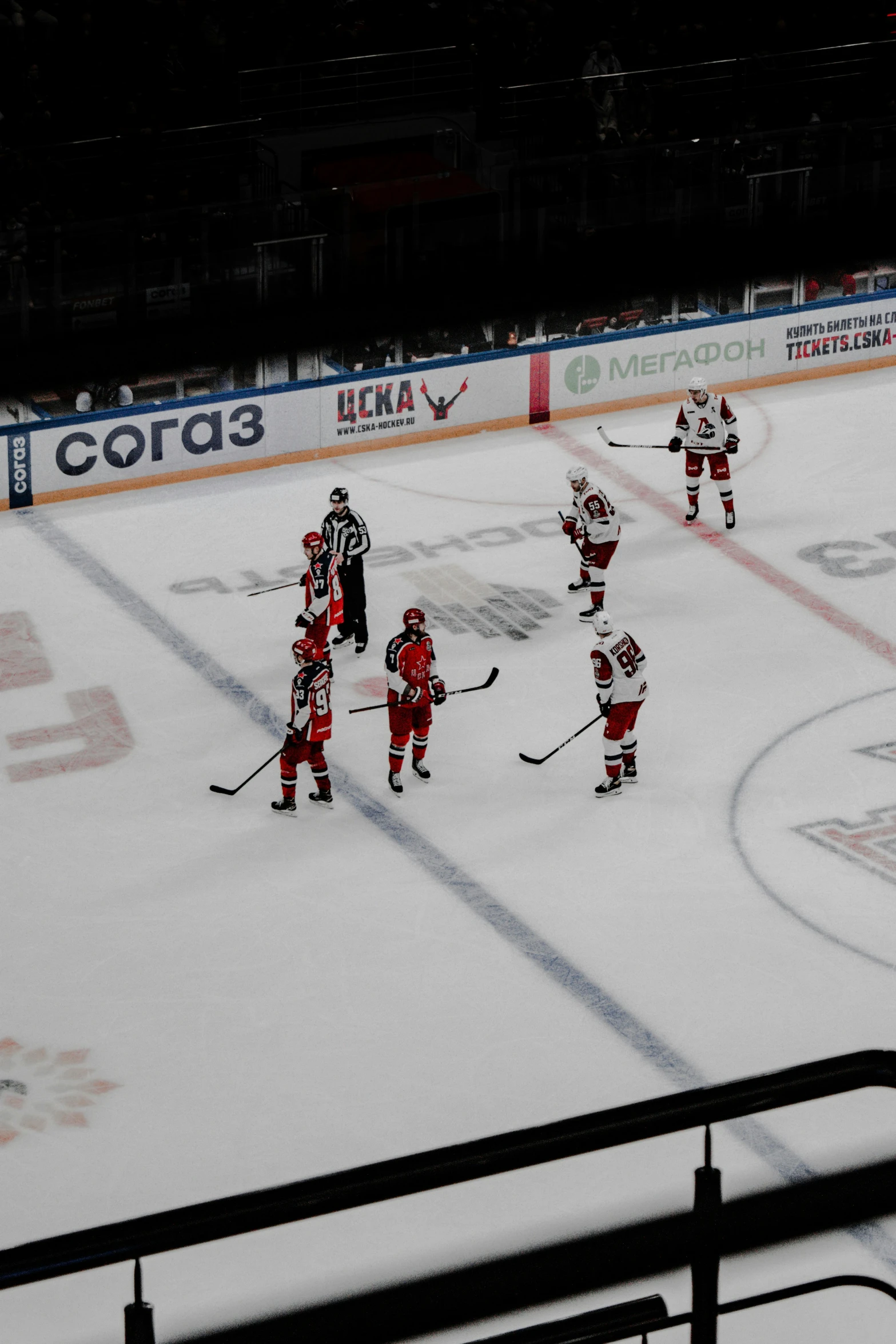 a group of people playing a game of ice hockey