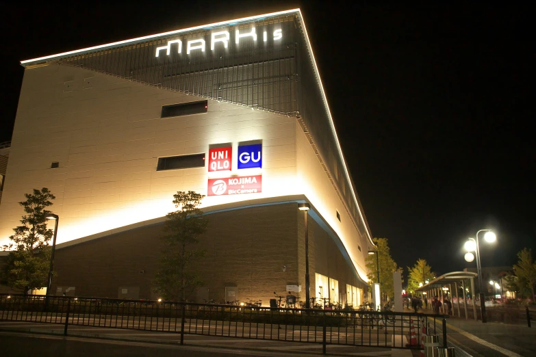 a large building lit up at night with lights around