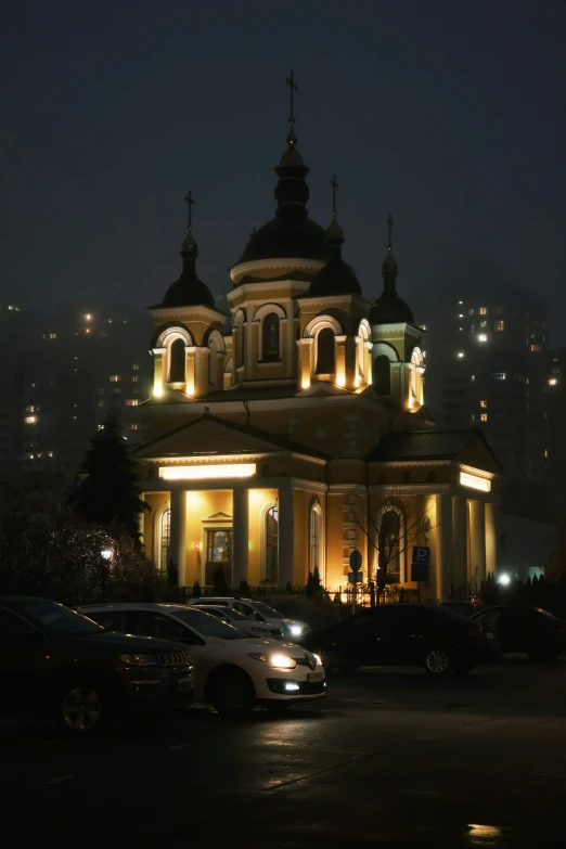 an ornate building has lights lit up around it