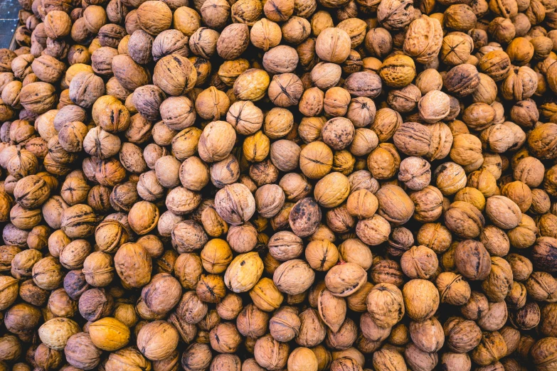 several walnuts piled high up and ready to be sold