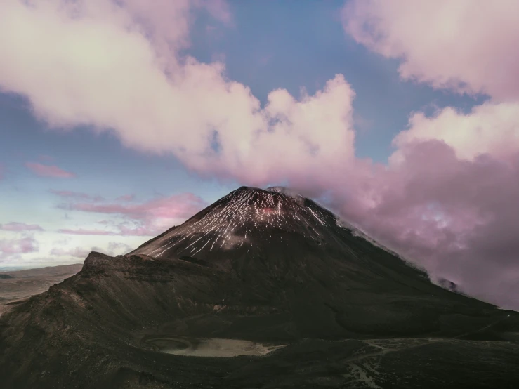 a mountain with some rocks and some clouds