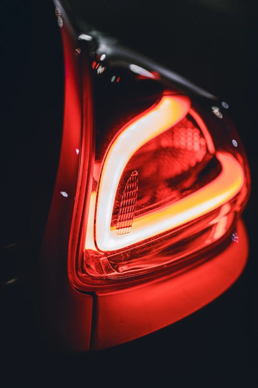 close up of an automobile's tail light in the dark