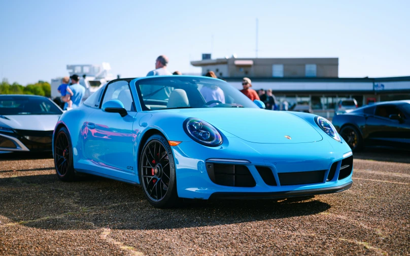 there is a blue porsche carros parked near a white one