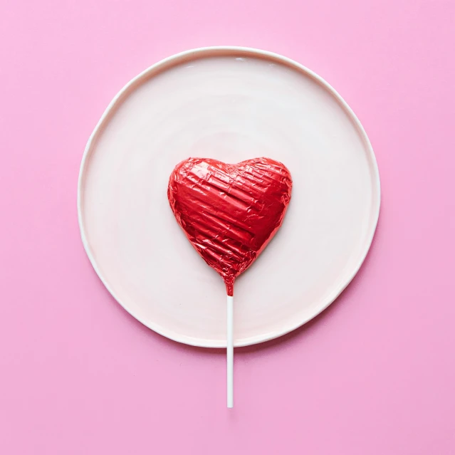 lollipop heart shaped on a pink background