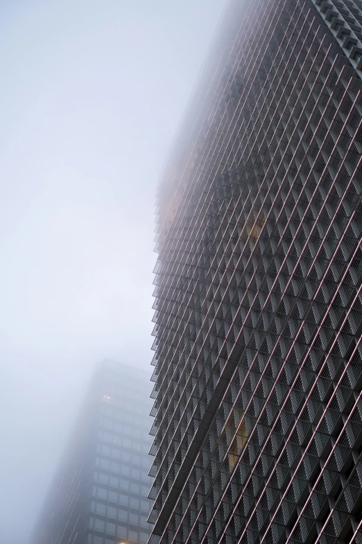 a view of a tall building in the fog