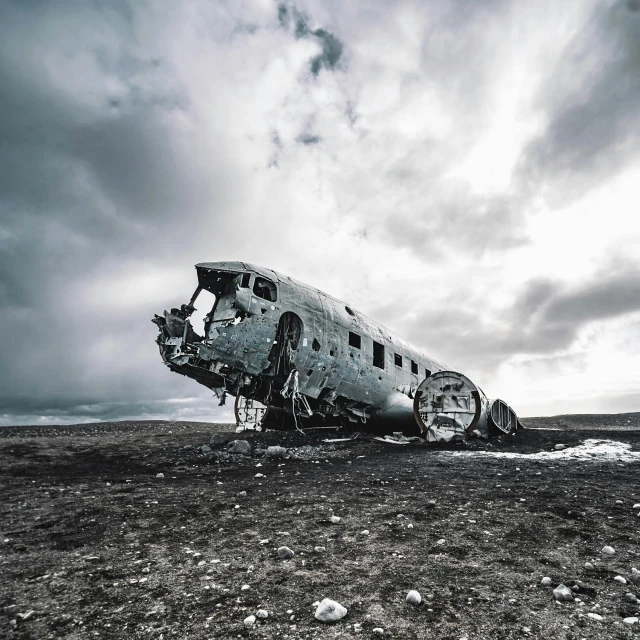 the underside view of an old airplane, sitting on dry land