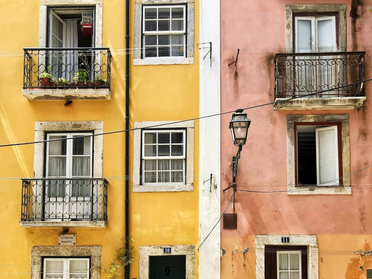 two houses are side by side with a balcony on each side