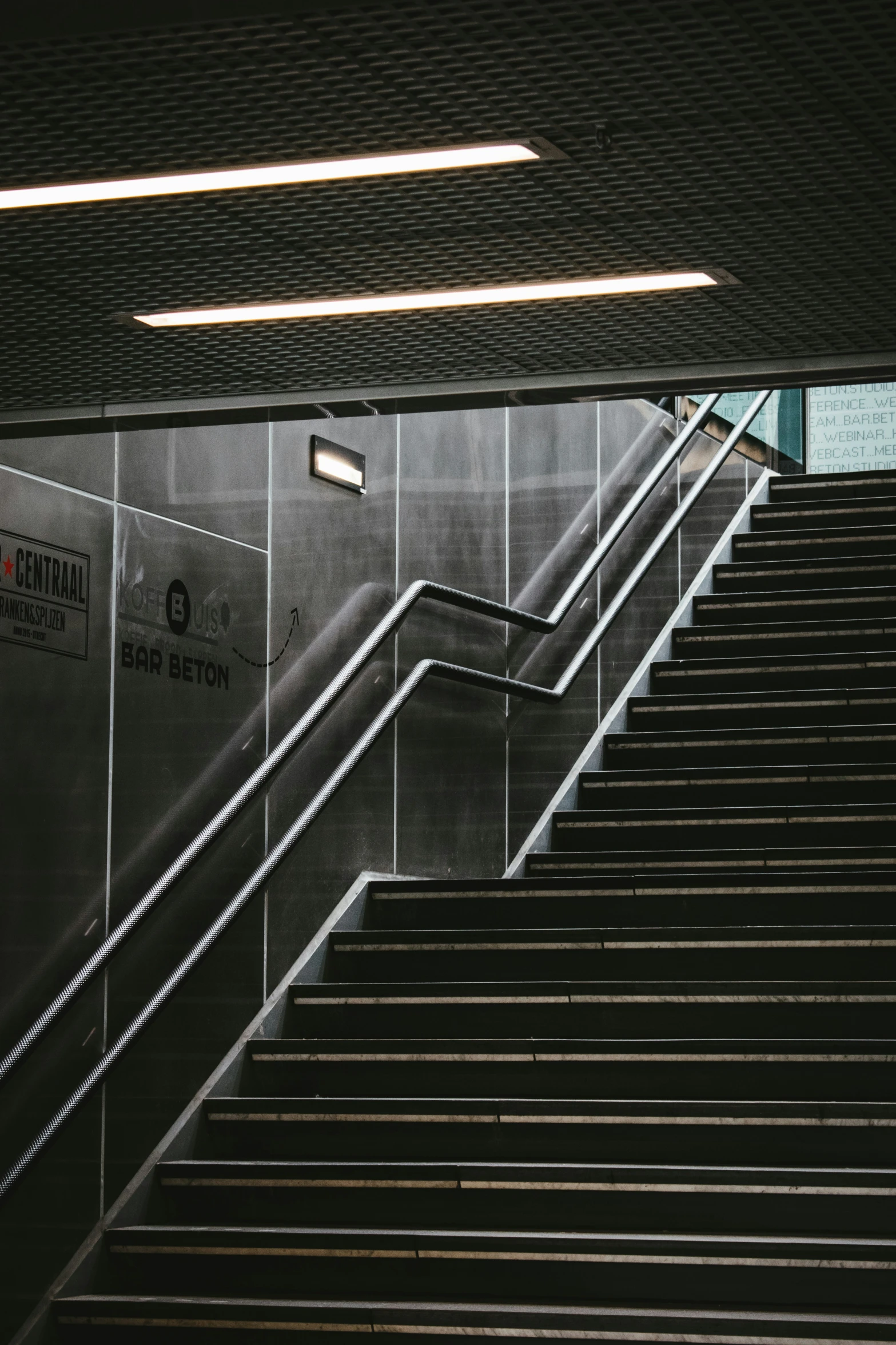 a man with a suitcase stands on an escalator