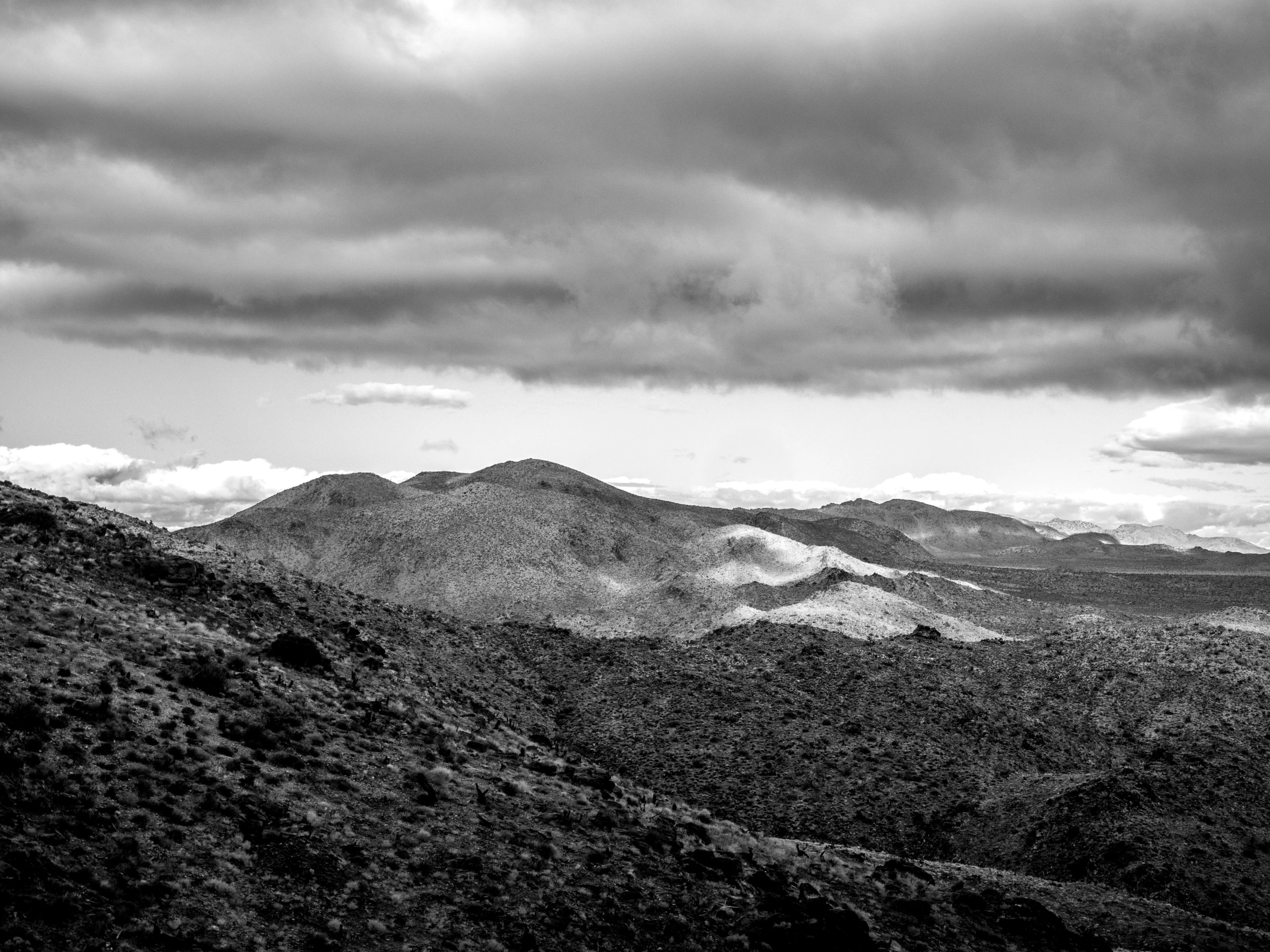 a mountain valley with a very dark sky