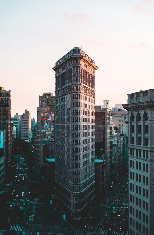 a city with tall buildings on the sides and a pink sky in the background