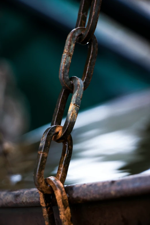 a chain hangs from a metal object