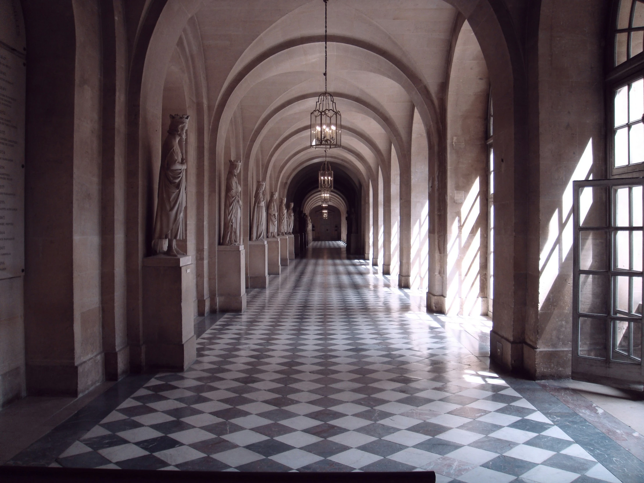 hallway inside a castle with ornate tiled floors