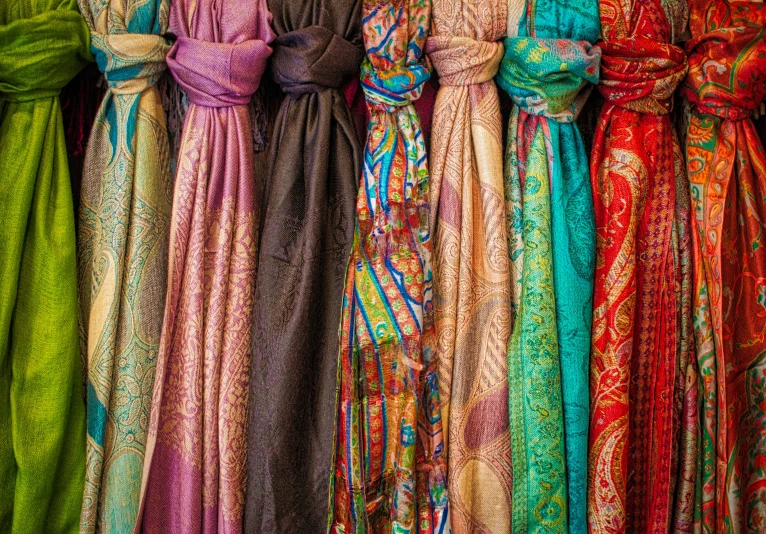 long dresses hanging in front of each other on display