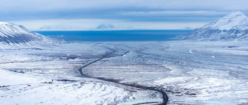 an aerial view of an icy mountain valley