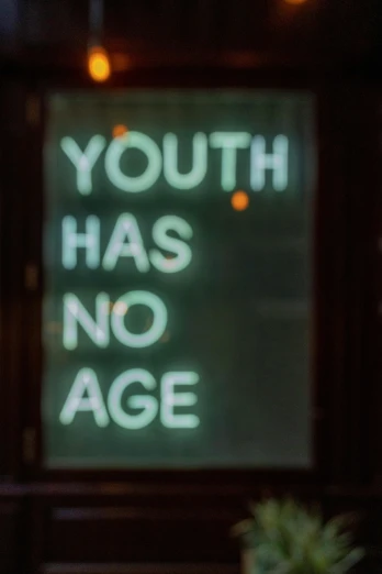 sign saying youth has no age with a vase of flowers