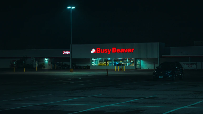the front view of a grocery store lit up at night