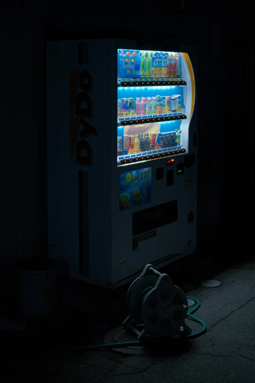 a vending machine lit up by a lamp