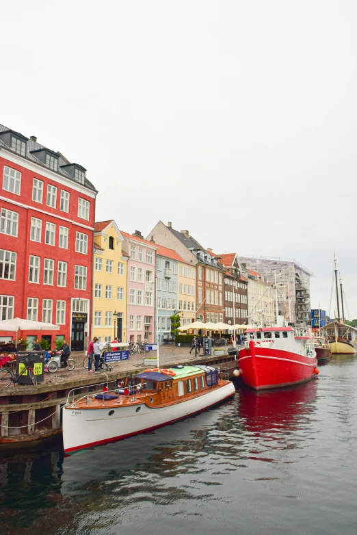 some red boats in the water and many buildings