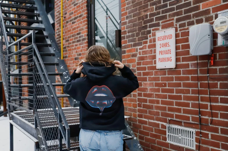 a girl in a black sweatshirt has a picture of a truck