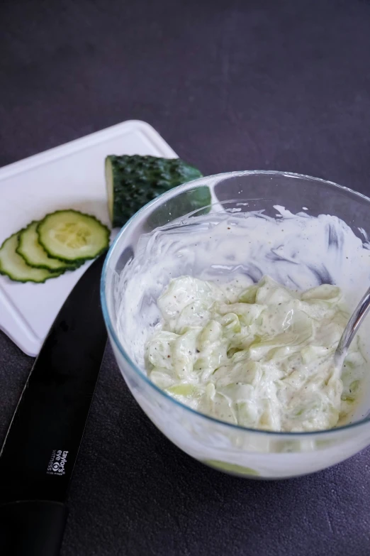 the bowl is filled with vegetables and cucumbers